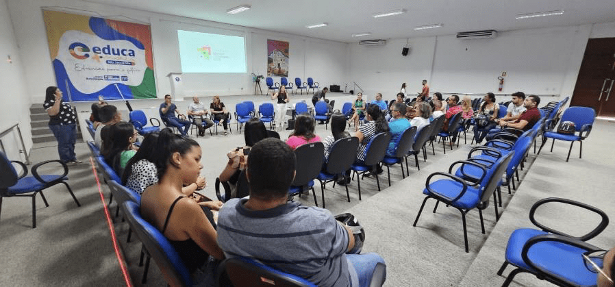 a presentation being given to a large room of people