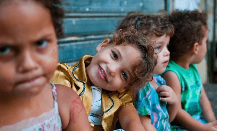 Faces of children, including a beautiful smiling girl, sitting in their neighborhood in the old city of Sidon, Lebanon.