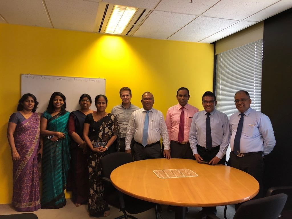 group photograph in front of a round table