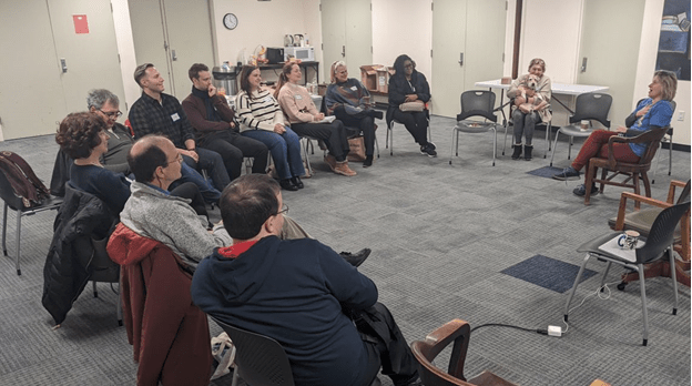 a group sitting in a circle meeting