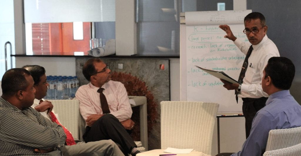 meeting taking place around a white board