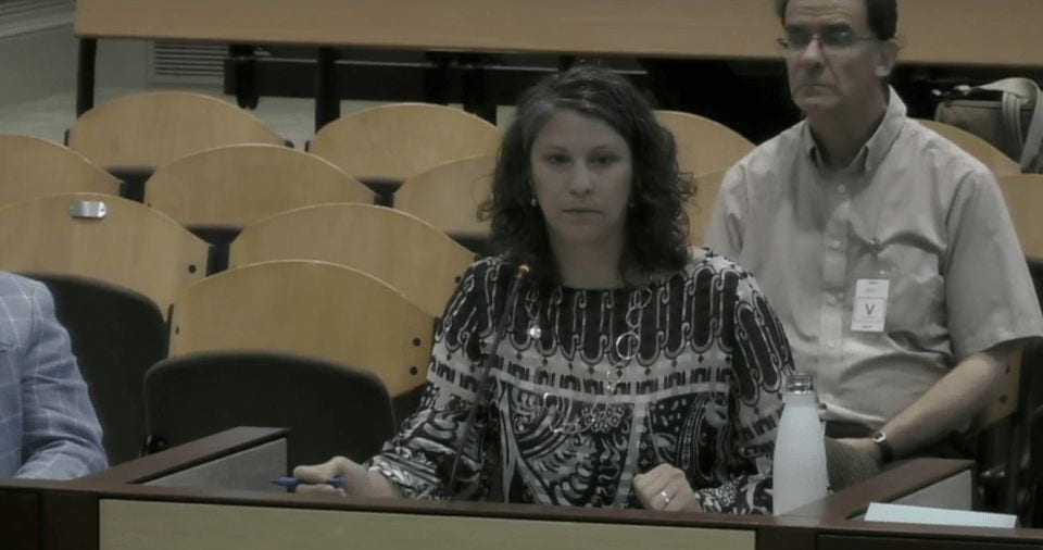 woman sitting to provide counsel in court