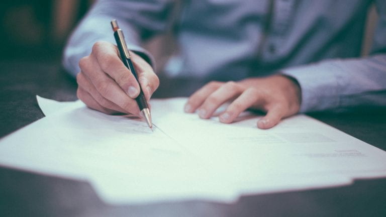 A person filling out paperwork