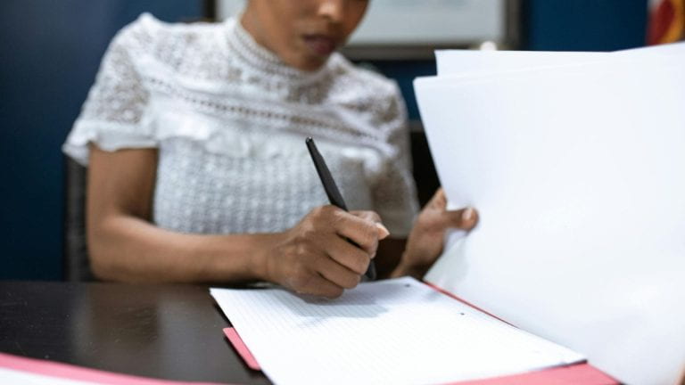 A person writing on paper