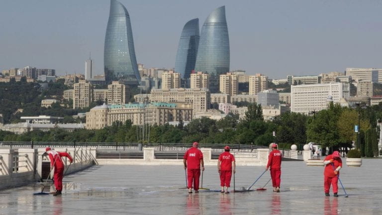 Workers cleaning the ground in Azerbaijan
