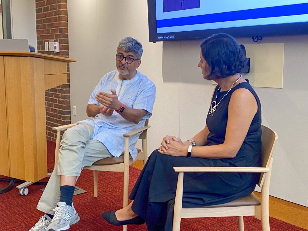 Rakesh Rajani speaking seated next to Salimah Samji