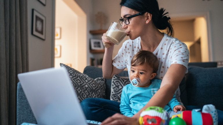 A mother working with a child in her lap