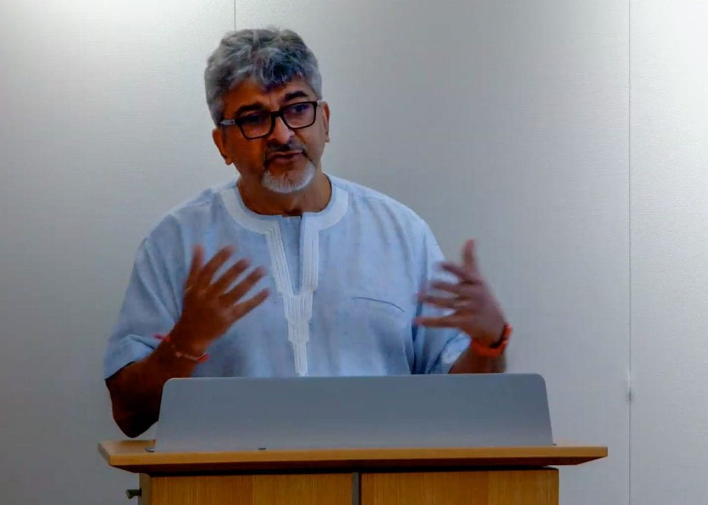 Rakesh Rajani speaking at podium