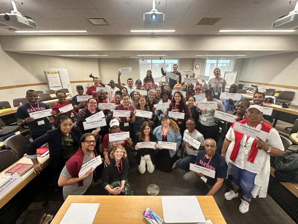 Cohort 2024 in classroom with teaching team holding nametags