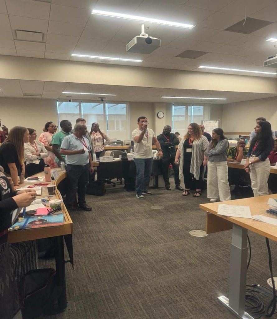 Participants throwing paper airplanes during class exercise