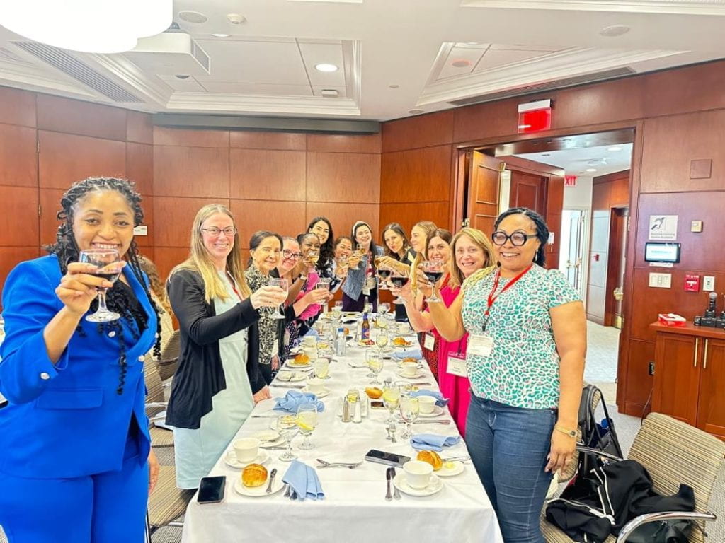 Participants smiling at final dinner on campus