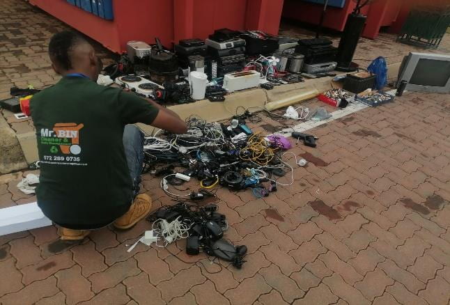 A man sorts through electronic waste