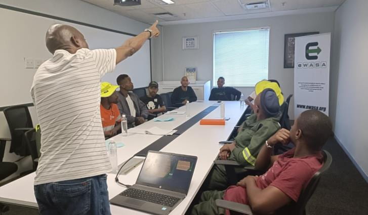 A man pointing during a discussion at a table