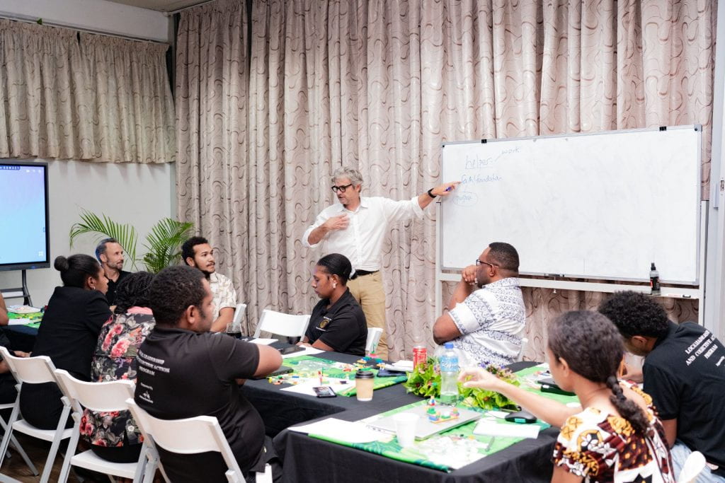 Matt Andrews presenting a concept on the whiteboard