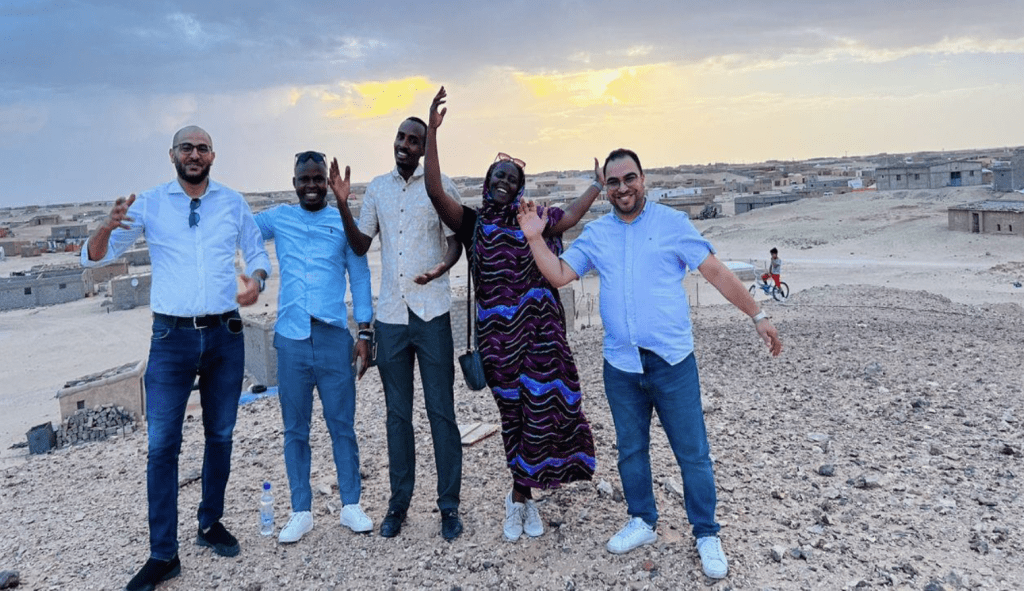 Group photo at refugee camp at sunset