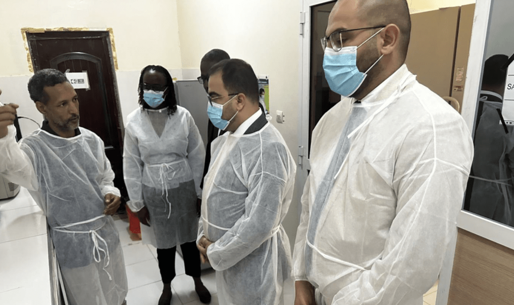People wearing protective clothing and face masks during laboratory field visit