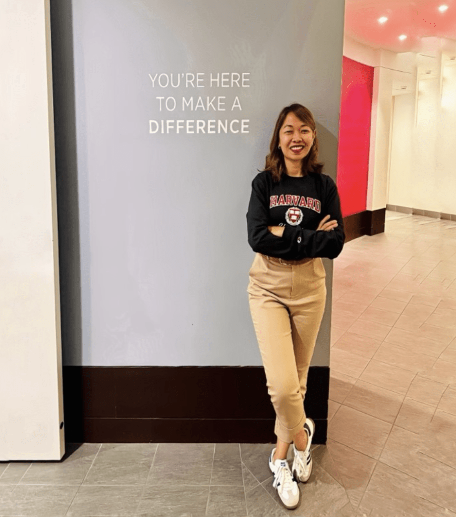 Fatima posing with sign "You're here to make a difference"