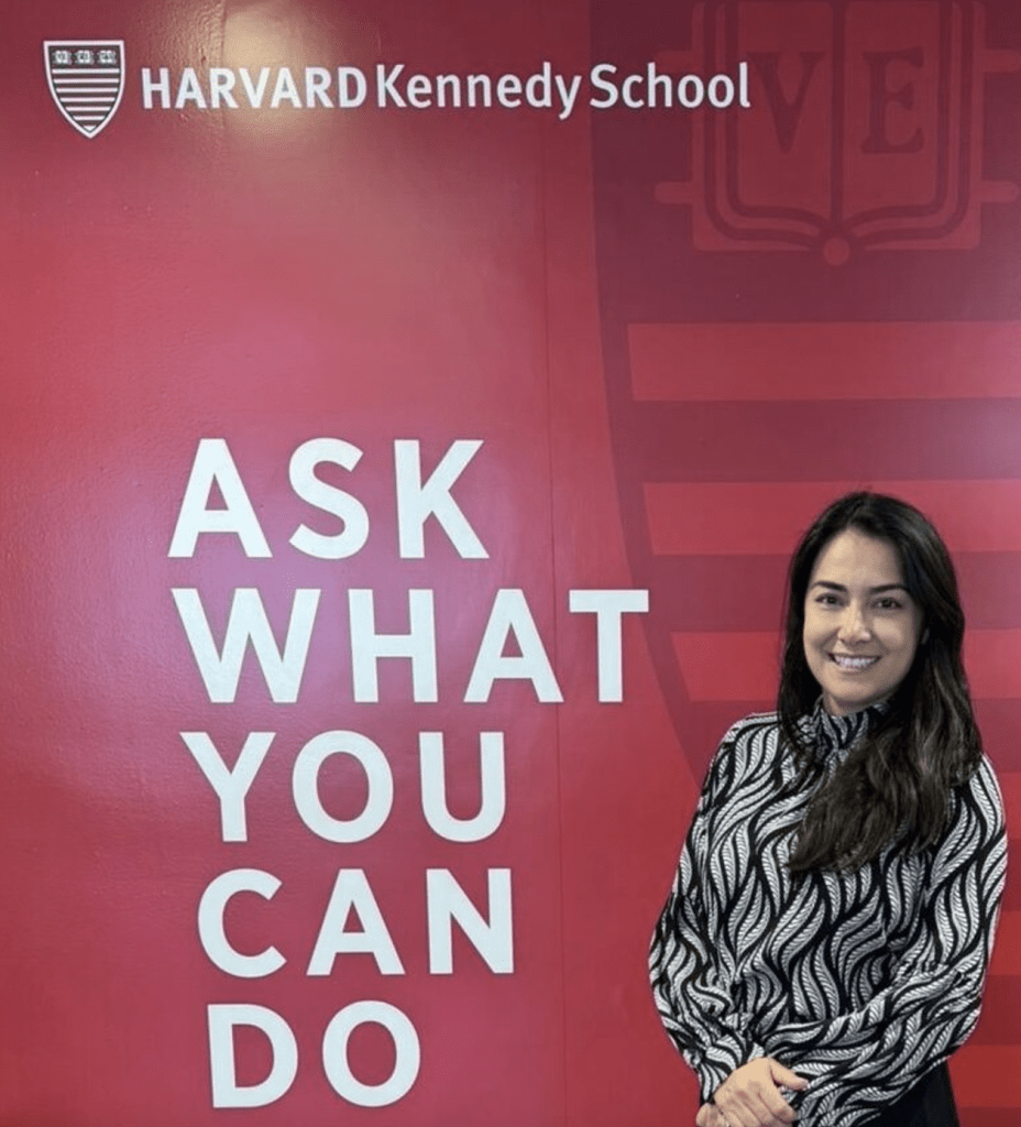 Ellen with sign "Ask what you can do" at HKS