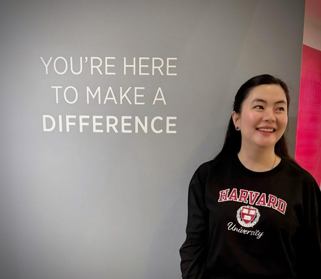 Susan with sign "You're here to make a difference" at HKS