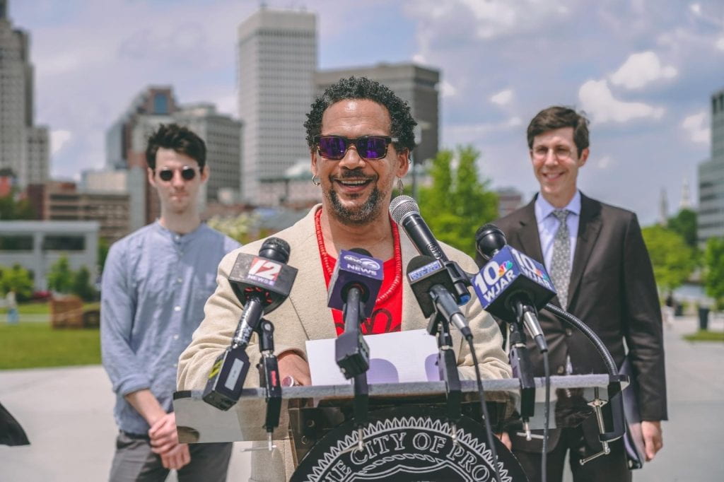 Joseph presenting with two people standing in the background