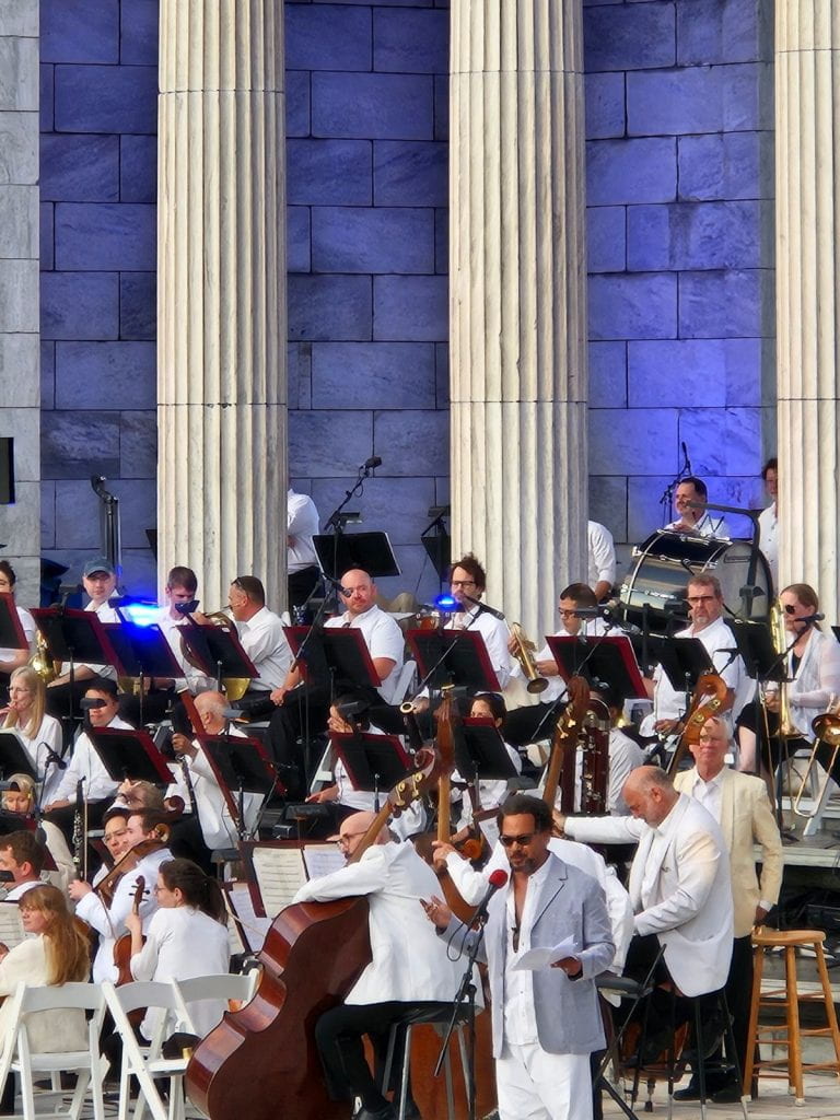 Joseph presenting with band in background