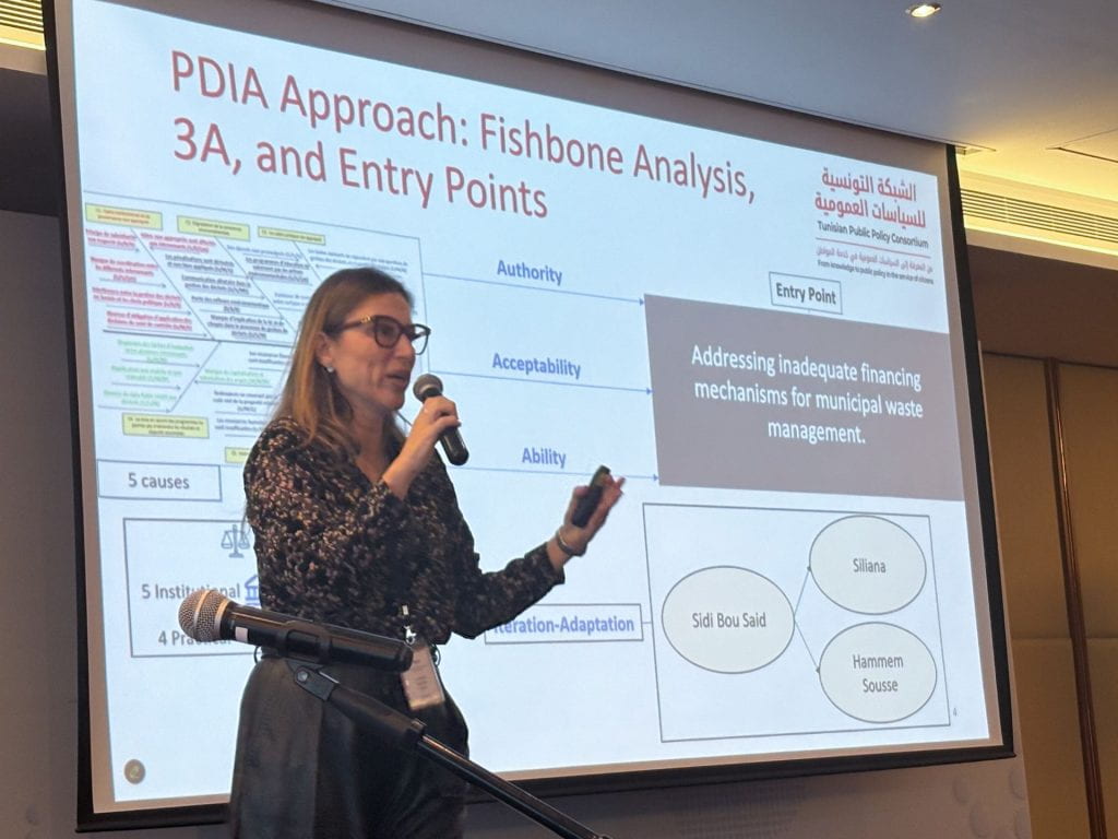 Lobna presenting with slides in background