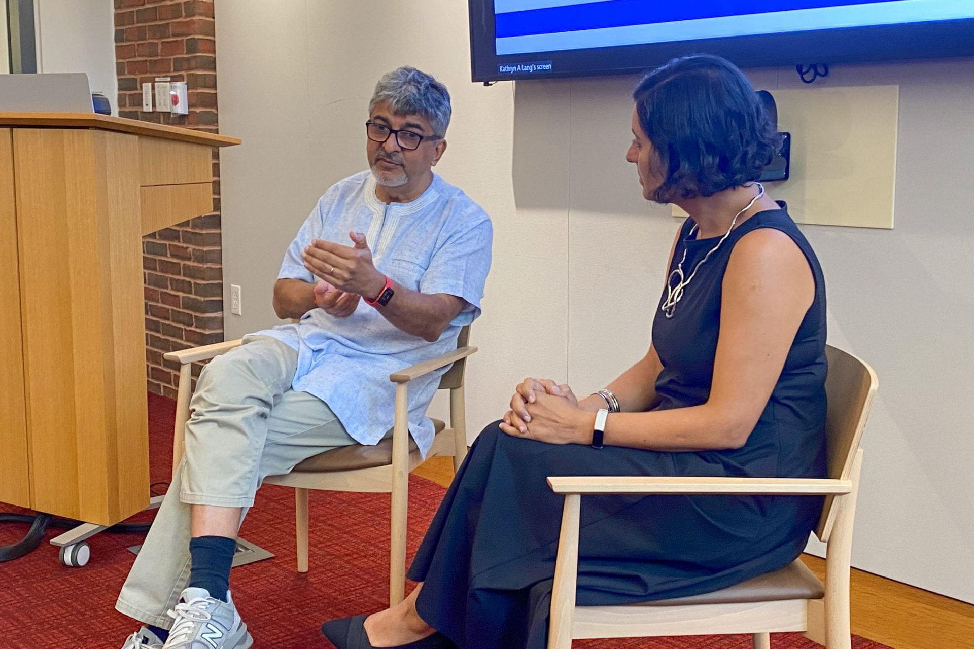 Rakesh Rajani speaking seated next to Salimah Samji