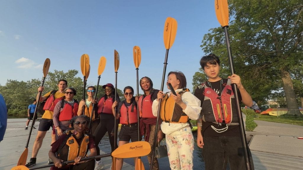 Participants posing with kayak paddles