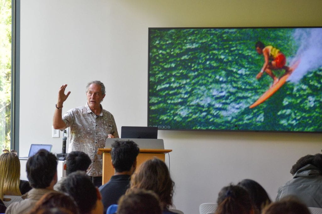 Shaun Tomson presenting with surfing image in background