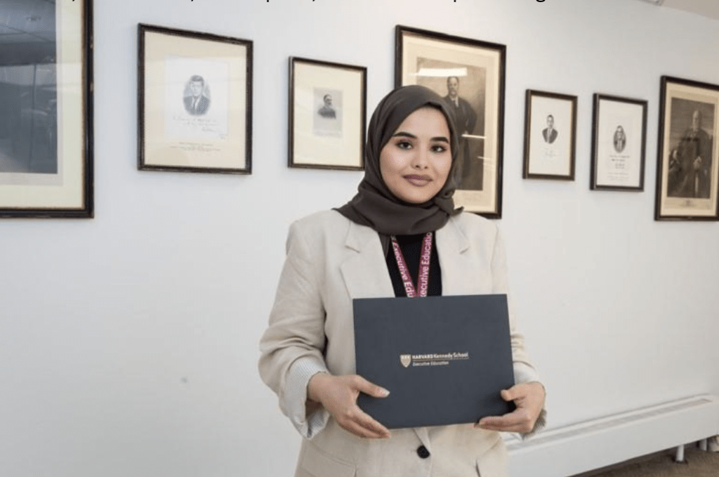 Mariam Alkarbi holding her certificate at Harvard Kennedy School