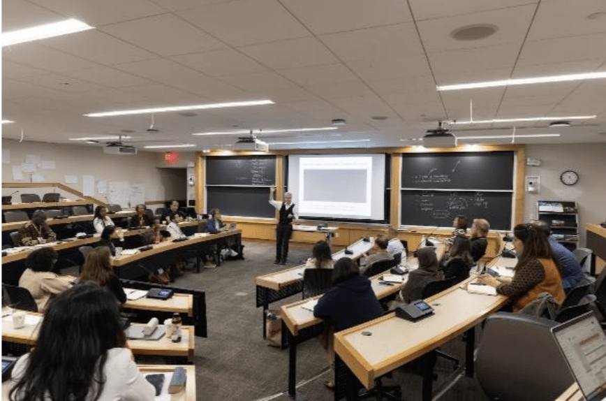 A photo of IPP'25 in the class room with Matt Andrews teaching in the front.