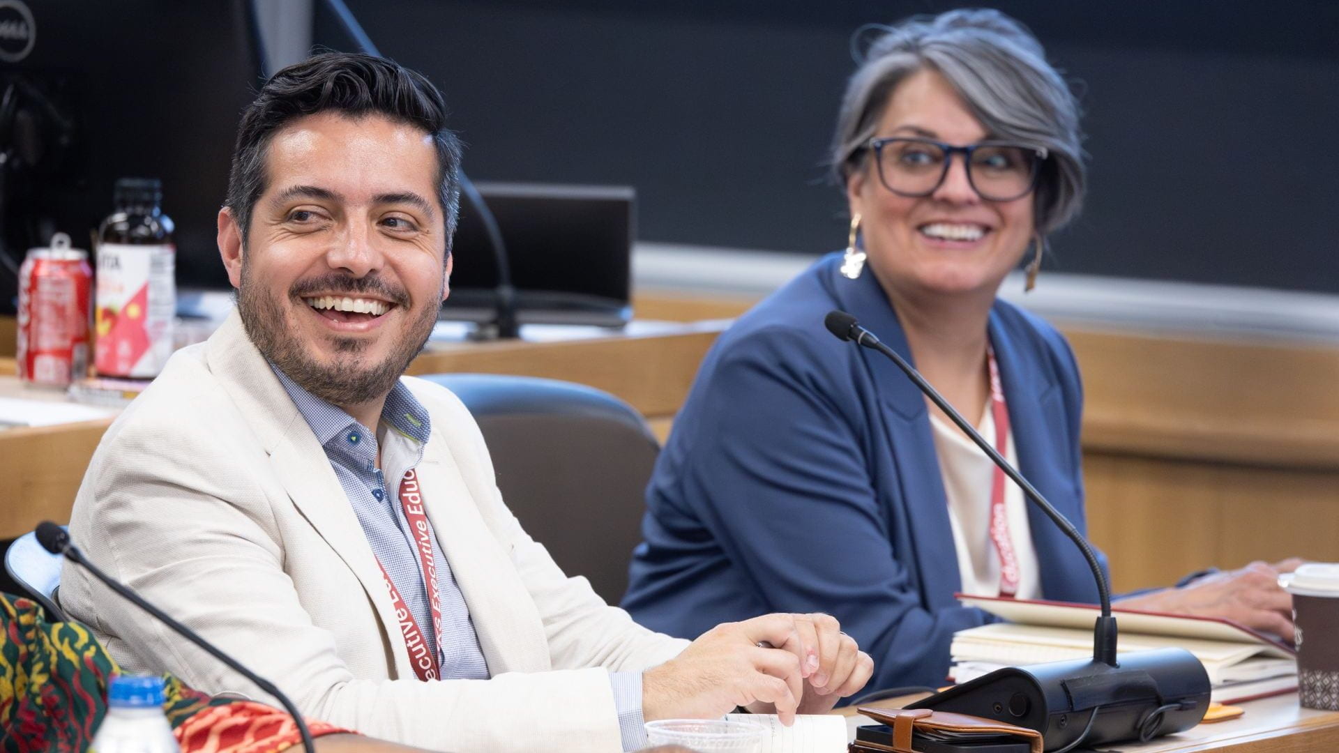 Executive education participants smiling in class