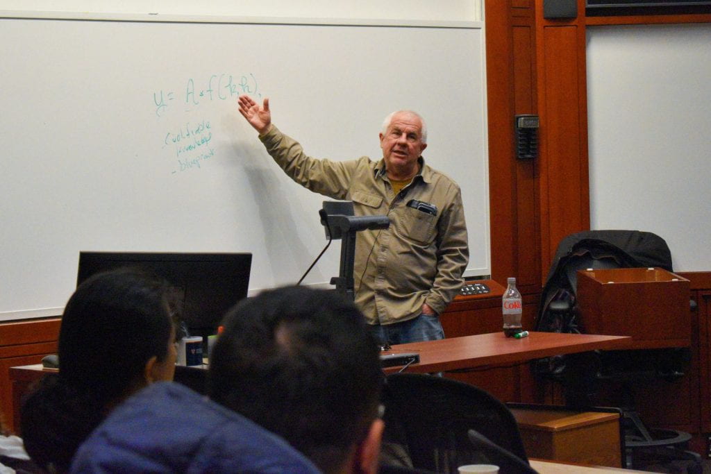 Lant Pritchett presenting and pointing to whiteboard
