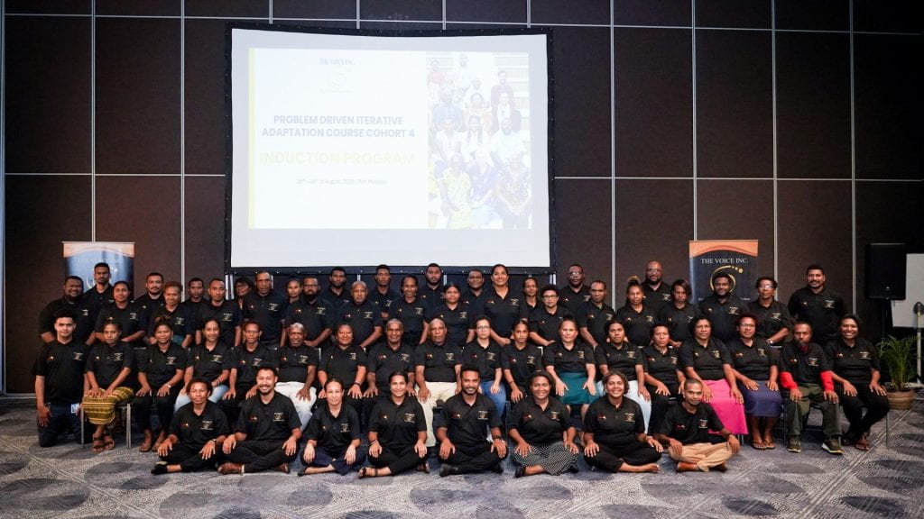 PNG participant group photo with slide "Problem Driven Iterative Adaptation course cohort 4" in background