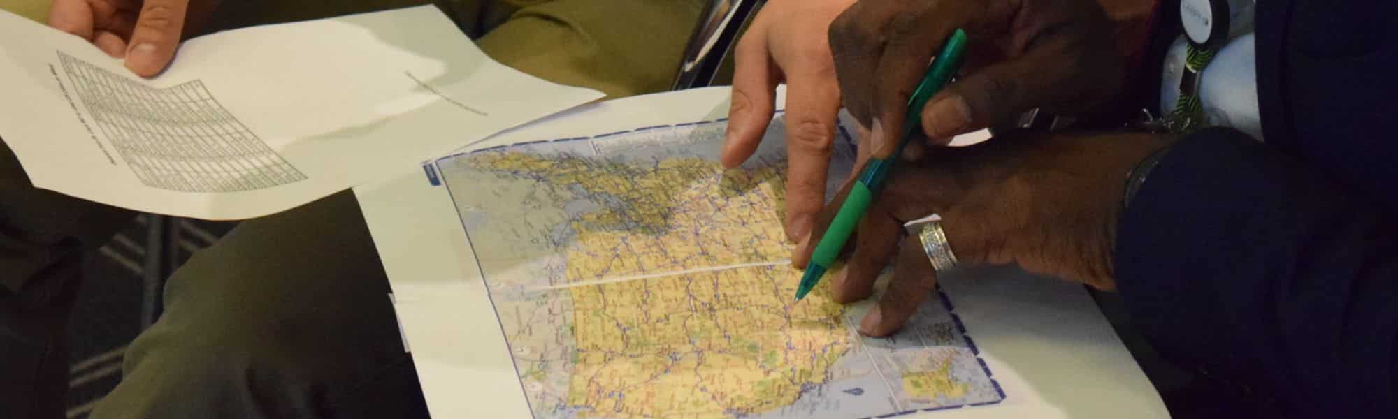 Hands pointing to a map
