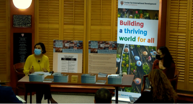 Salimah Samji and Fatima Sumar presenting with CID branded banner in background and books on a table.