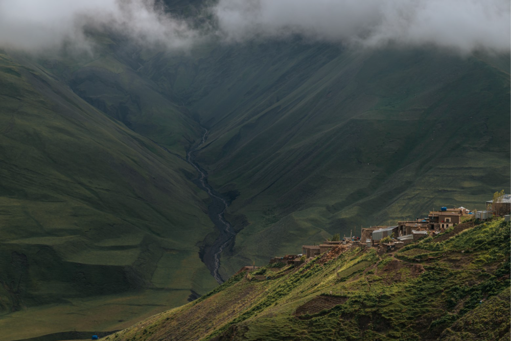 The photograph shows Khinalig, an ancient high-mountain village in Azerbaijan, surrounded by the demanding landscape of the Greater Caucasus. Known for its pastoral traditions, Khinalig is connected to highland summer pastures and lowland winter pastures by the 200-kilometre migration route. This cultural landscape was inscribed on the UNESCO World Heritage List.