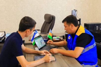 Volunteers working on a computer together.